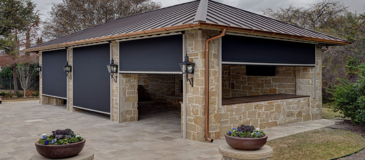 Outdoor stand-alone patio space with retractable motorized screens.